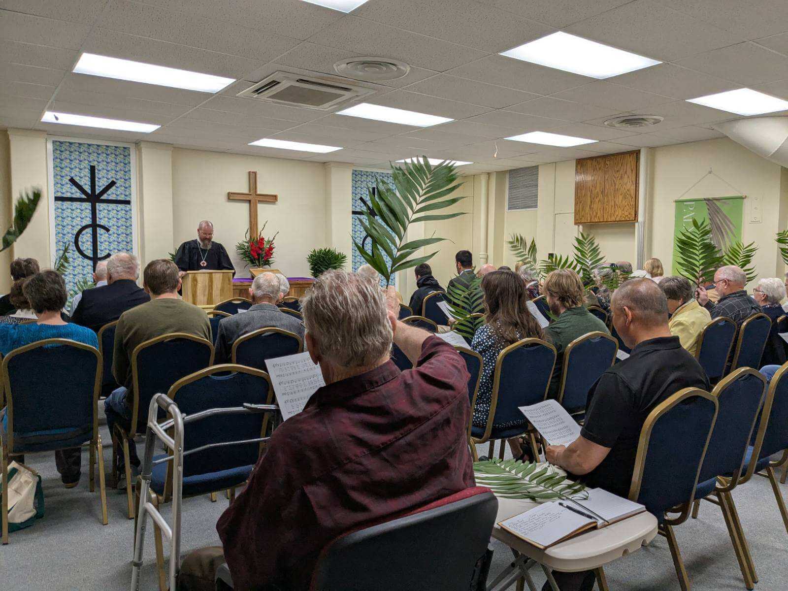 Some members of Christ the King singing hymns from the hymnal during worship